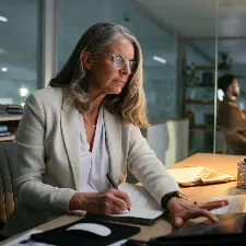 woman working at desk looking at computer screen