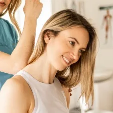 woman having neck adjusted