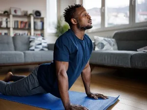 man doing yoga on a mat