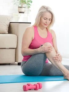 Older woman holding knee