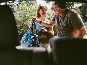 man and woman packing car