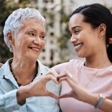 two woman caring heart