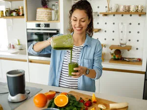 woman making a smoothie