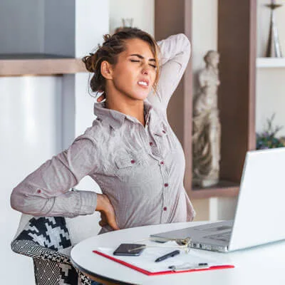young-soman-at-computer-back-and-neck-pain-sq-400