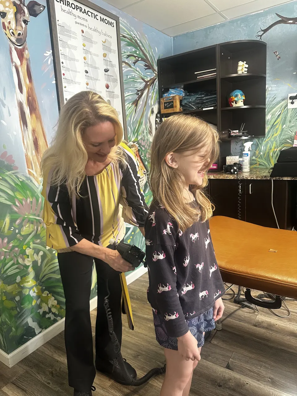 Dr. Anna Saylor adjusting a young girl with the KST instrument