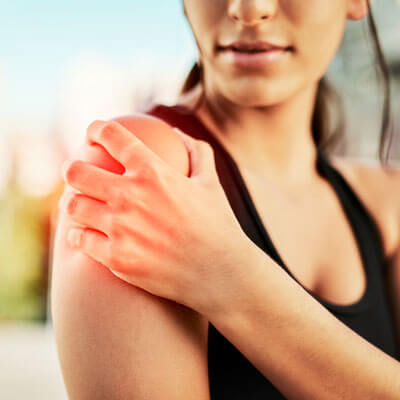 Person holding their shoulder in pain