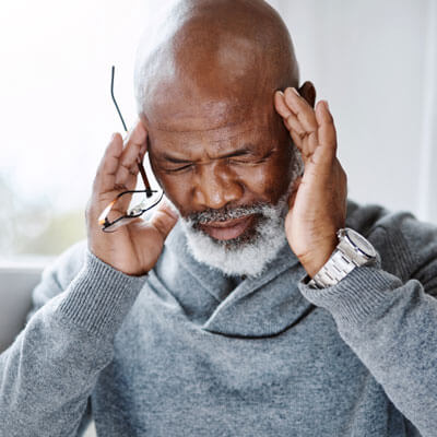 Man holding his temples in pain