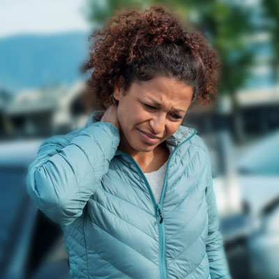 Person holding their neck after a car accident