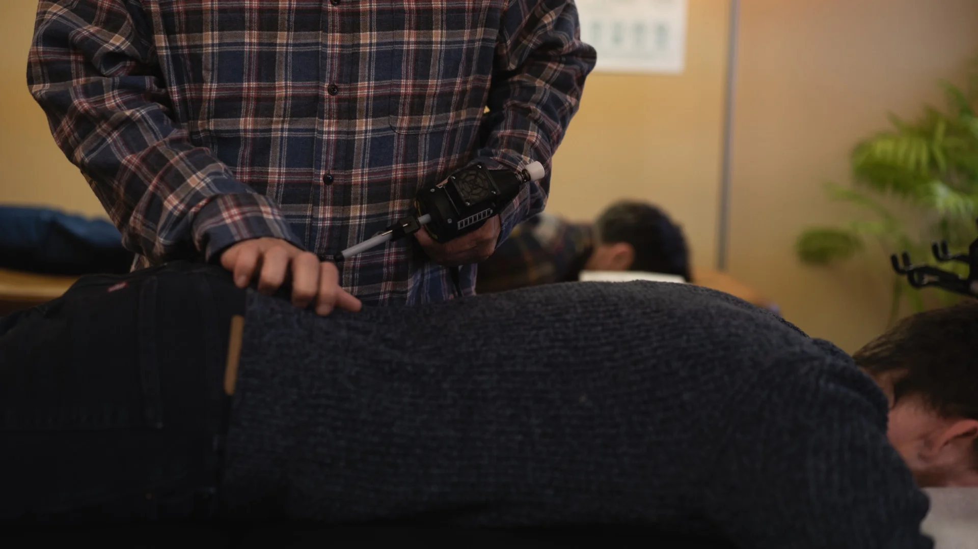 Dr. Anna Saylor using the ArthroStim instrument for Koren Specific Technique chiropractic adjustment