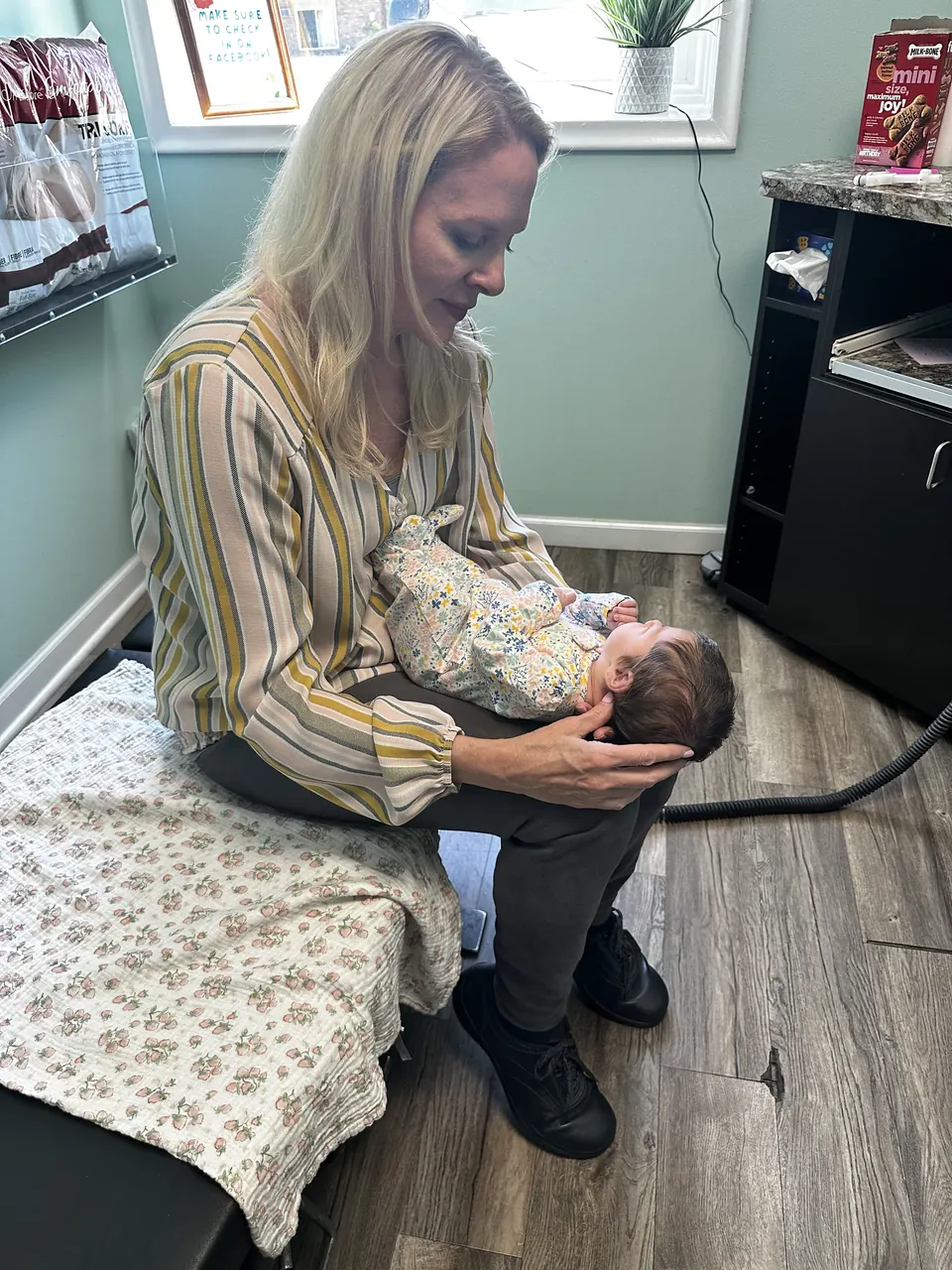 Dr. Anna Saylor cradling an infant during a gentle visit