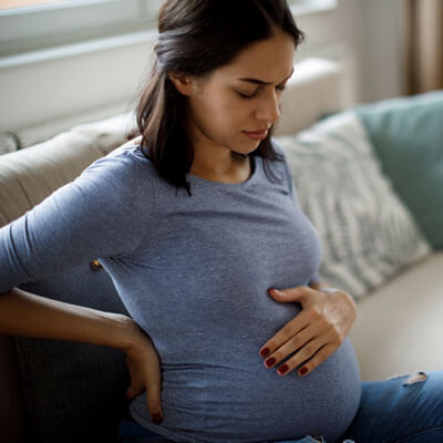 Pregnant woman experiencing discomfort in her lower back and pelvis